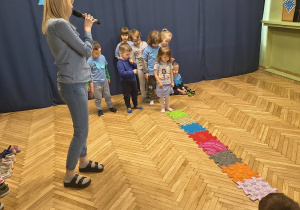Na zdjęciu Pani Martyna wraz z dziećmi, dzieci chodzą po ścieżce sensorycznej